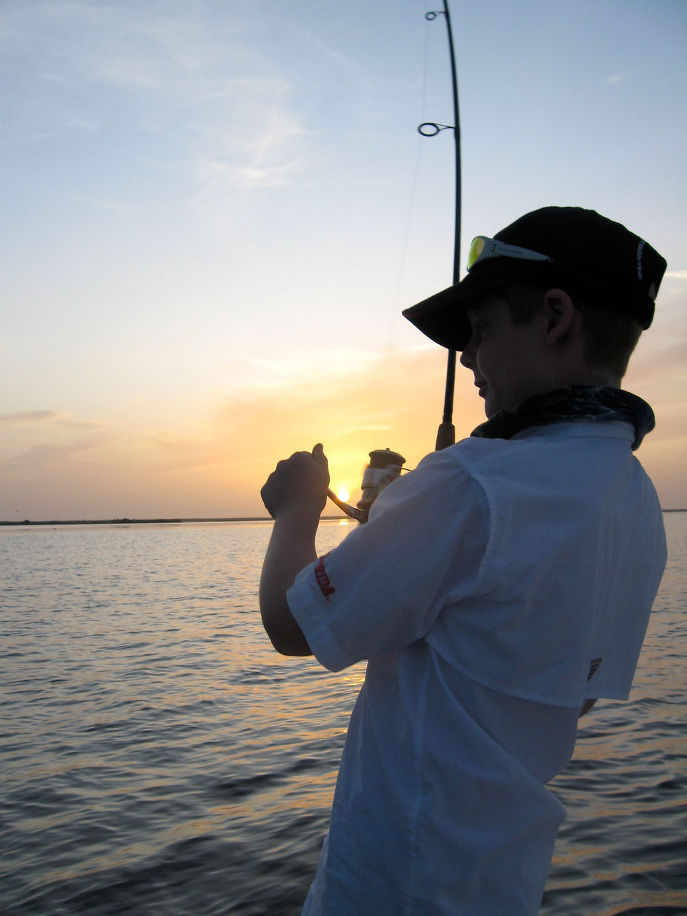Young angler fishing into the sunset on the Mosquito Lagoon